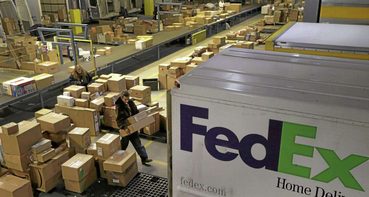 Workers sort packages at a FedEx sorting facility. Middletown Mayor Dan Drew and planning officials are hoping the company will build a similar hub in town at the old Aetna site.
