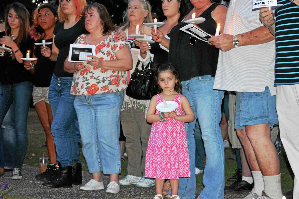 After three weeks missing, family and friends of Nina Coe, 56, of Middletown say it’s getting “harder and harder every day” to pray she’ll be found safe and sound. Here, nearly 100 gather for a candlelight vigil on the South Green Aug. 5.