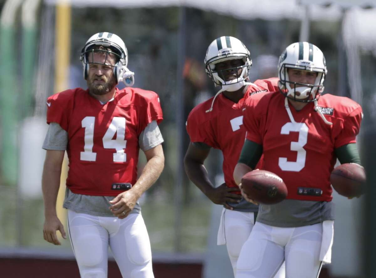 New York Jets quarterbacks Ryan Fitzpatrick (14), Geno Smith (7) and Jake Heaps (3) take part in drills during practice Wednesday in Florham Park, N.J.