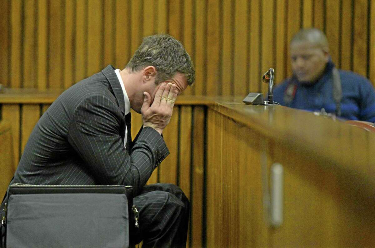 Oscar Pistorius, gestures, as he sits in court, during his trial in Pretoria, South Africa, Friday, Aug. 8, 2014. The chief defense lawyer for Oscar Pistorius delivered final arguments in the athlete's murder trial on Friday, alleging that Pistorius thought he was in danger when he killed girlfriend Reeva Steenkamp and also that police mishandled evidence at the house where the shooting happened.(AP Photo/Herman Verwey, Pool)