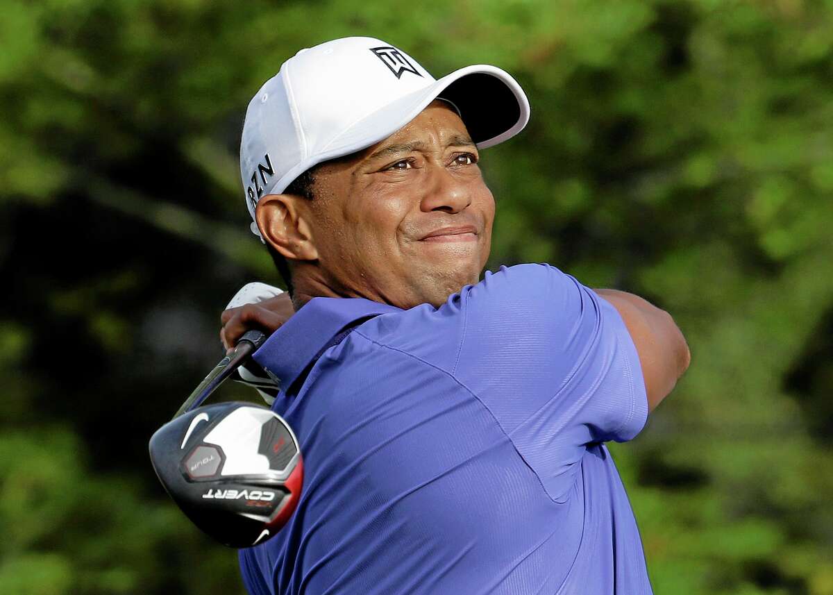 Tiger Woods watches his tee shot on the 10th hole during the first round of the PGA Championship golf tournament at Valhalla Golf Club on Thursday, Aug. 7, 2014, in Louisville, Ky. (AP Photo/John Locher)