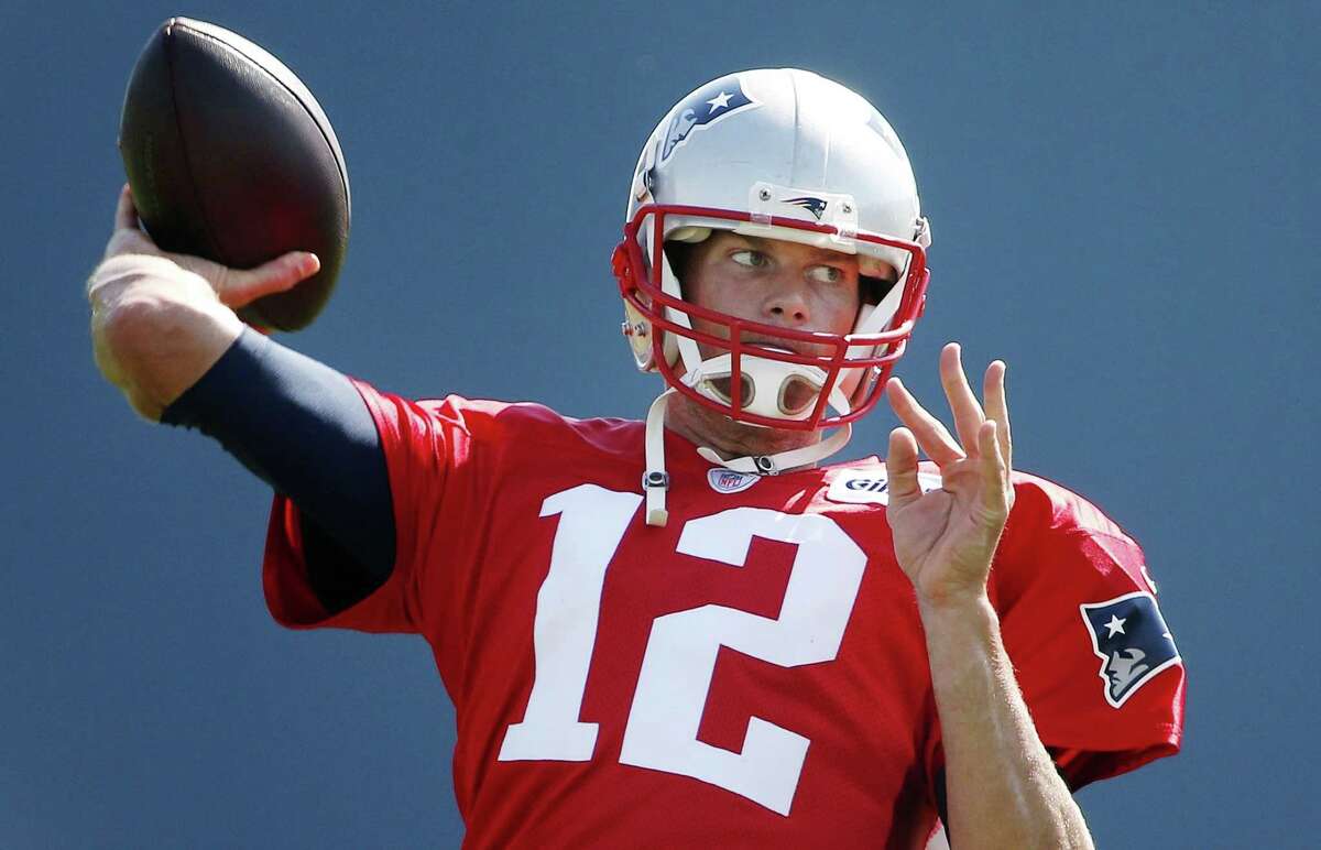 New England Patriots quarterback Tom Brady passes during training camp on Saturday in Foxborough, Mass.