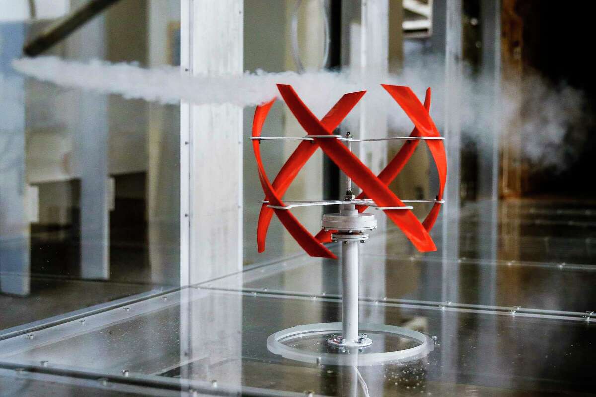 A stream of smoke in a wind tunnel flows past a 3D printed, helical shaped wind turbine model designed at the University of Houston Friday, Aug. 11, 2017 in Houston. ( Michael Ciaglo / Houston Chronicle )