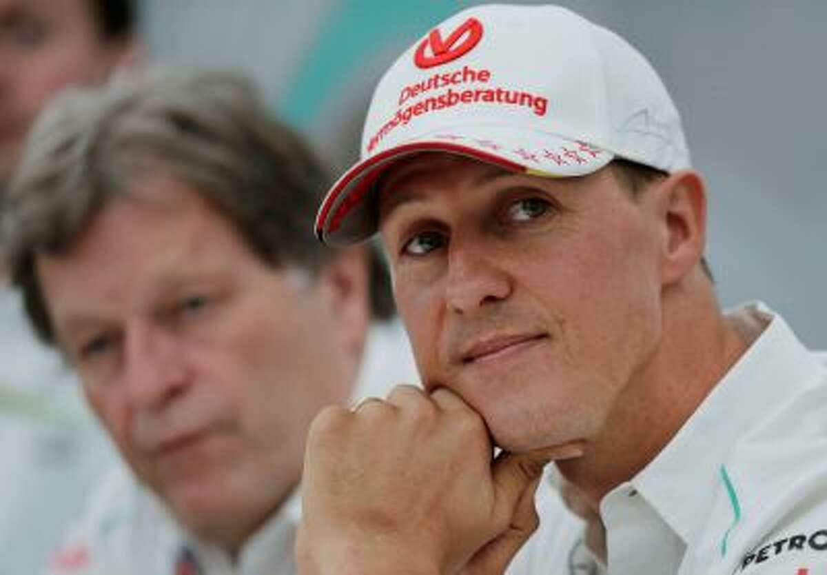 FILE - This is a Thursday, Oct. 4, 2012 file photo of Mercedes driver Michael Schumacher, right, of Germany sits with teammate Norbert Haug, during a news conference to announce his retirement from Formula One at the end of the 2012 in Suzuka, Japan. Michael Schumacher's manager said Friday April 4, 2014 that the retired Formula One star now "shows moments of consciousness and awakening," more than three months after suffering serious head injuries in a skiing accident. Manager Sabine Kehm said in a statement that "Michael is making progress on his way." She added that "we keep remaining confident." (AP Photo/Shizuo Kambayashi, File)