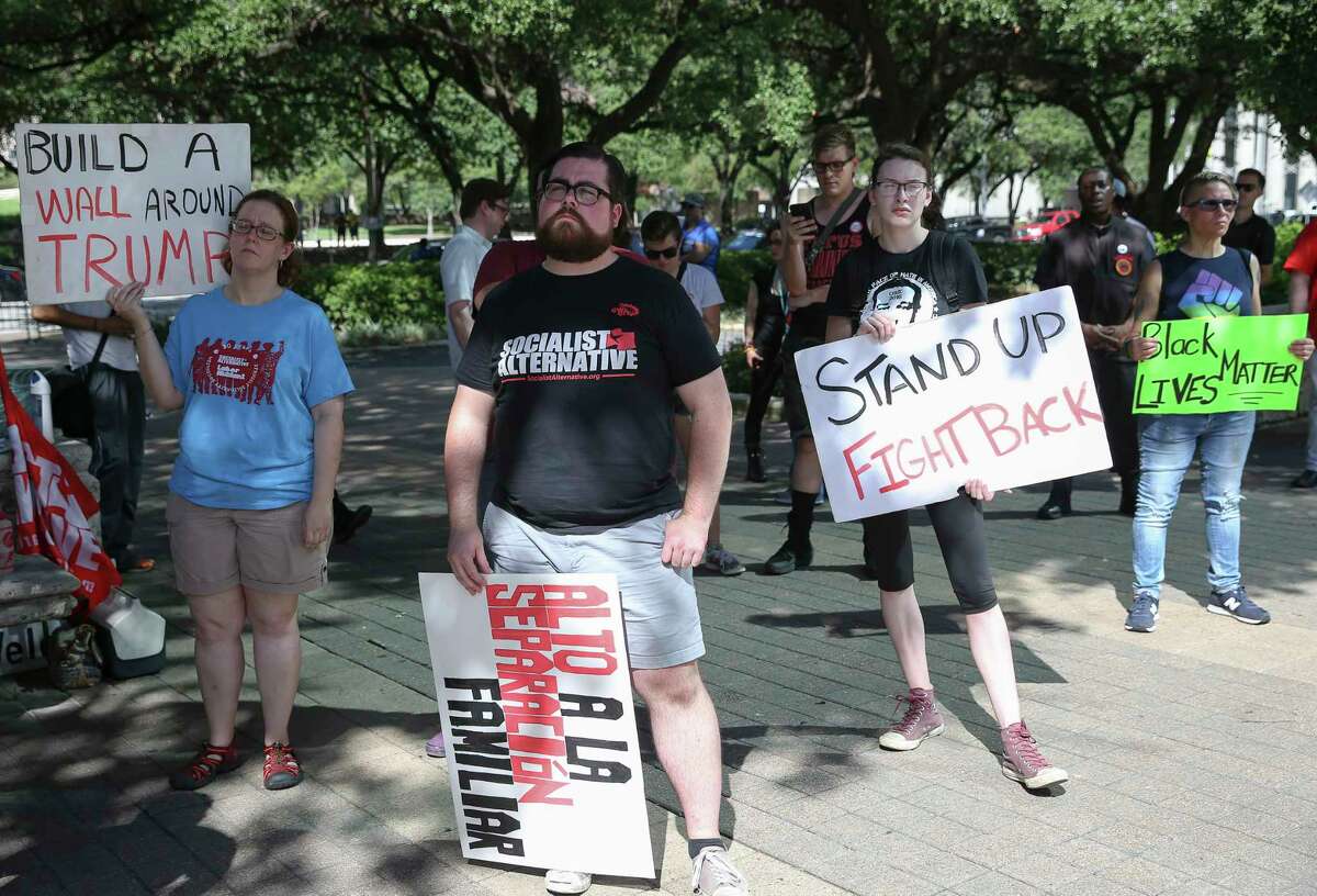 Anti-Senate Bill 4 groups gather at Houston City Hall for a rally Saturday, Aug. 12, 2017, in Houston. Groups of SB4 supporters also gathered across Walker Street to speak their mind.