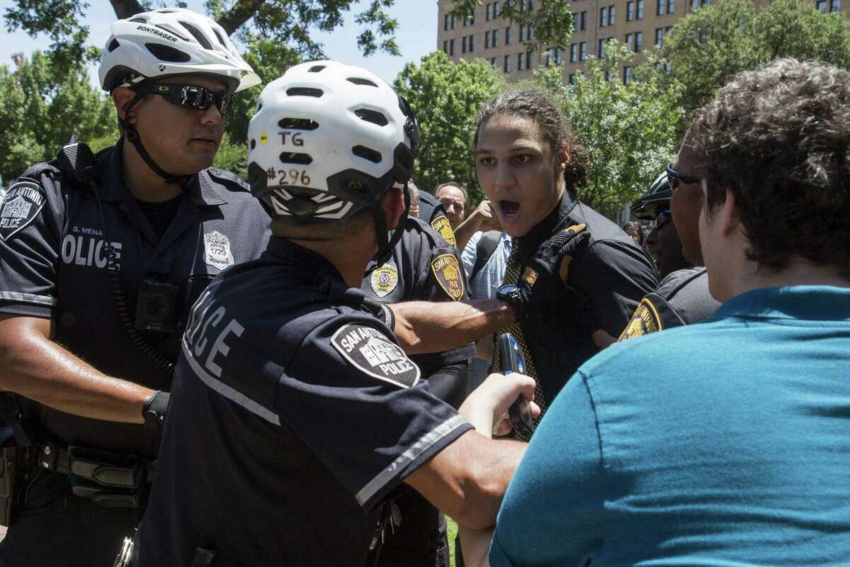 Michael Murphy reacts to being pushed back by police during a rally held by SATX4 to support the removal of the confederate monument in Travis Park in San Antonio, Texas on August 12, 2017. Murphy was apprehended soon after. Texas Freedom Force, a group dedicated to protecting Texas history, hosted a rally to protest the removal of the confederate monument. At the same time, SATX4, a community organization similar to Black Lives Matter, held a counter-protest.