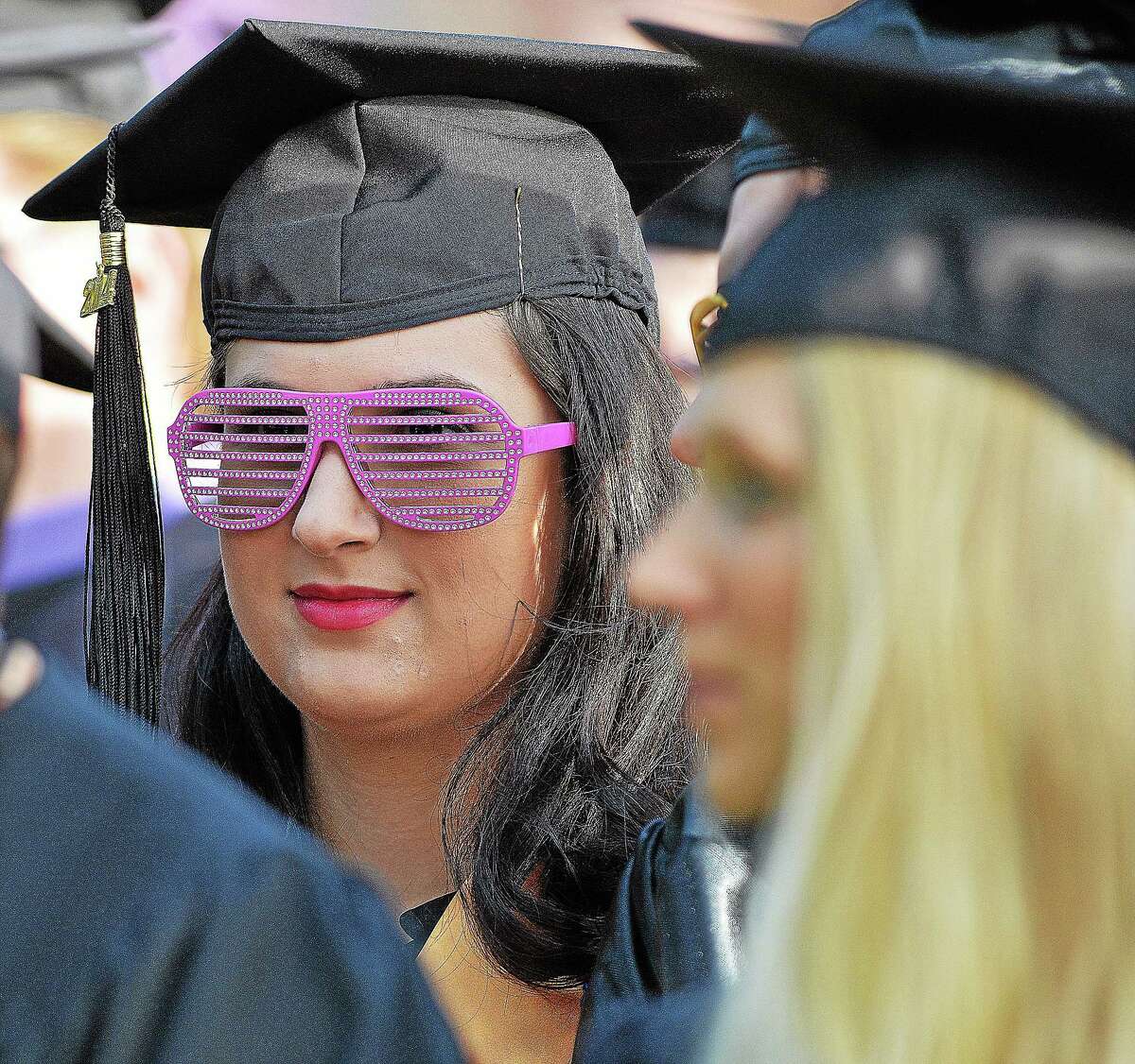 A member of Middlesex Community College listens to student representative Gina Layman give her speech to the class of 2014 Thursday evening.