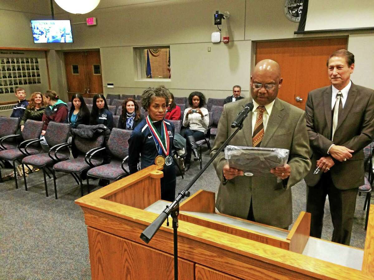 Councilman Grady Faulker reads the proclamation to his wife Jennette Starks-Faulkner, a championship fencer.