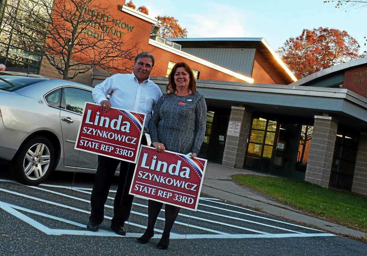 Republican challenger Linda Szynkowicz stands with a supporter outside the Snow School voting district in Middletown.