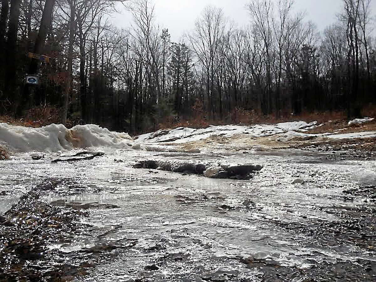 Runoff from melting snow and ice descends Massa Tom Road off of Country Club Road.
