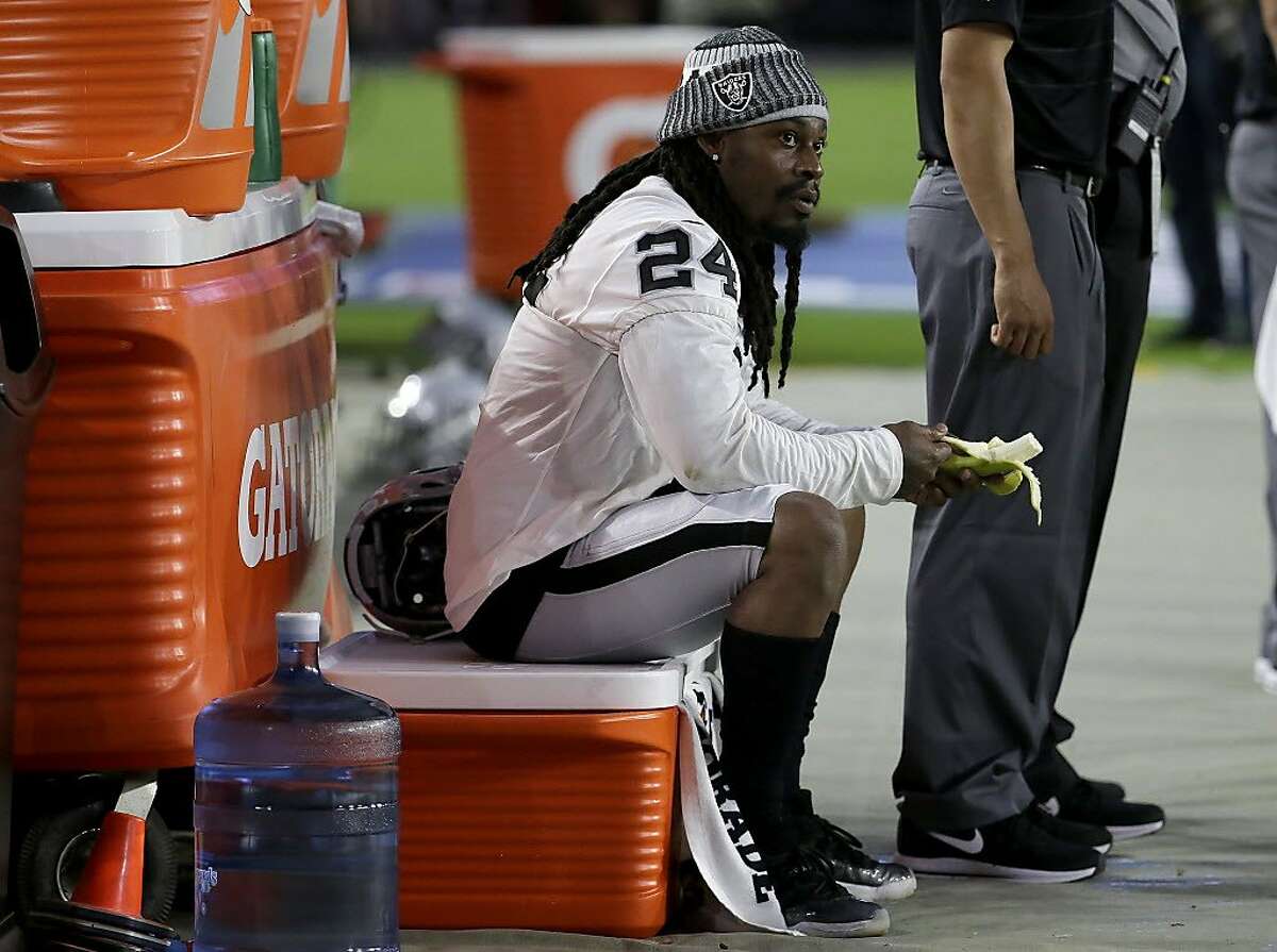 Oakland Raiders running back Marshawn Lynch (24) sits during the national anthem prior to the team's NFL preseason football game against the Arizona Cardinals, Saturday, Aug. 12, 2017, in Glendale, Ariz. (AP Photo/Rick Scuteri)