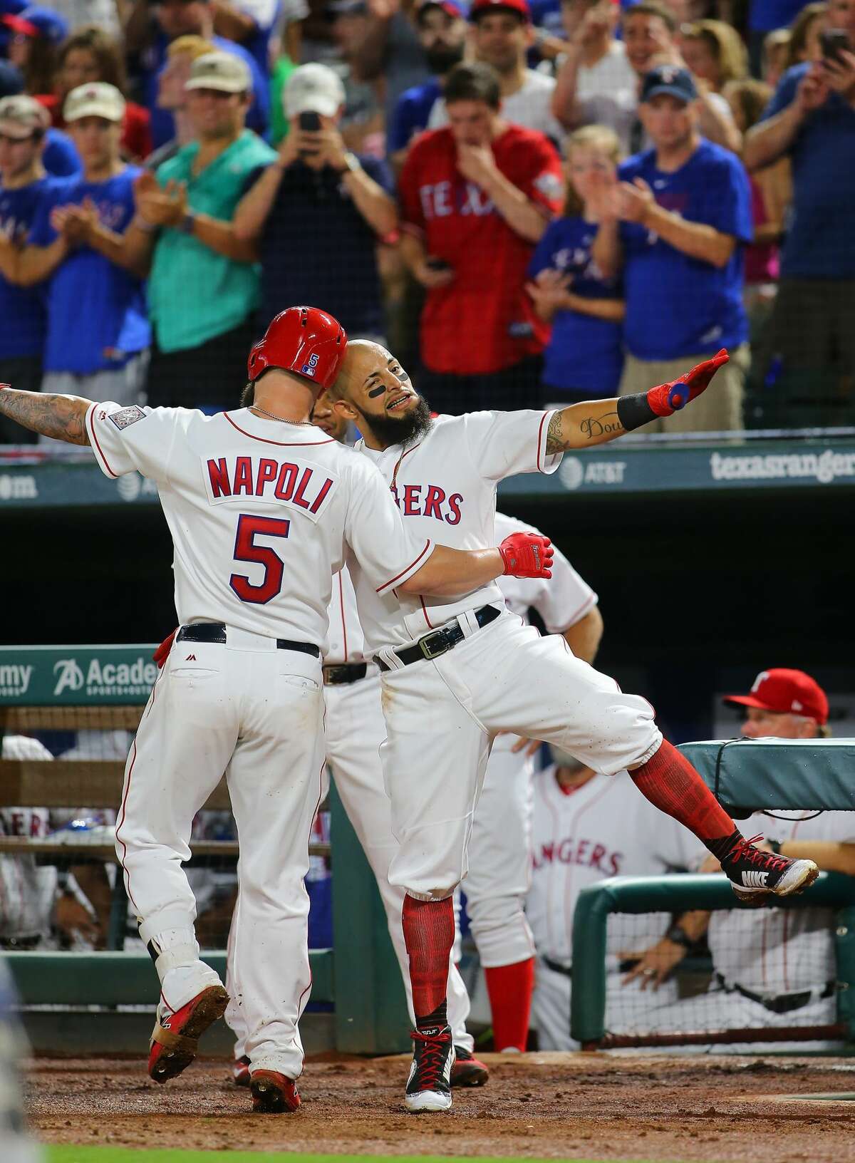 ARLINGTON, TX - AUGUST 12: Rougned Odor #12 of the Texas Rangers and Mike Napoli #5 celebrate Napoli hitting a solo home run in the fourth inning against the Houston Astros at Globe Life Park in Arlington on August 12, 2017 in Arlington, Texas. (Photo by Rick Yeatts/Getty Images)