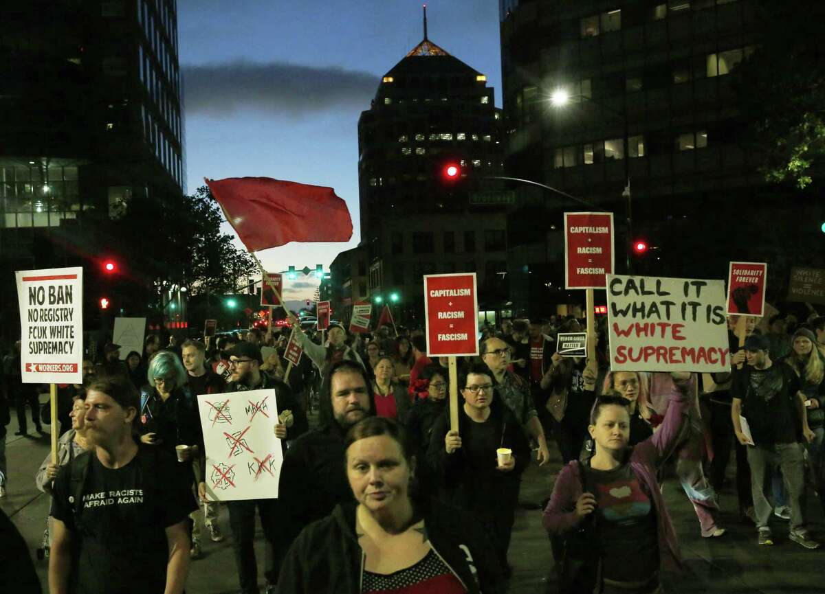 Marchers in downtown Oakland show solidarity with victims of a Charlottesville, Va., rally against white nationalists that turned deadly when a driver struck a crowd, killing a woman.