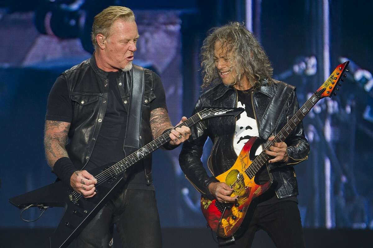 Metallica lead singer James Hetfield, left, salutes the crowd alongside  guitarist Kirk Hammett after playing he national anthem before a baseball  game between the San Francisco Giants and Los Angeles Angels on