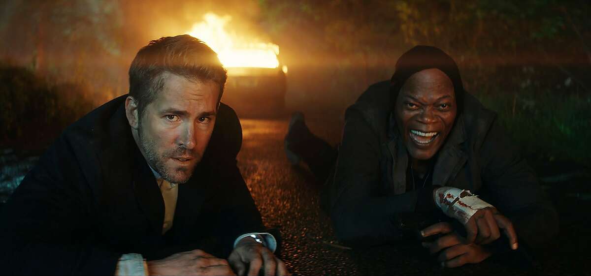This image released by Lionsgate shows Samuel L. Jackson, right, and Ryan Reynolds in "The Hitman's Bodyguard." (Lionsgate via AP)