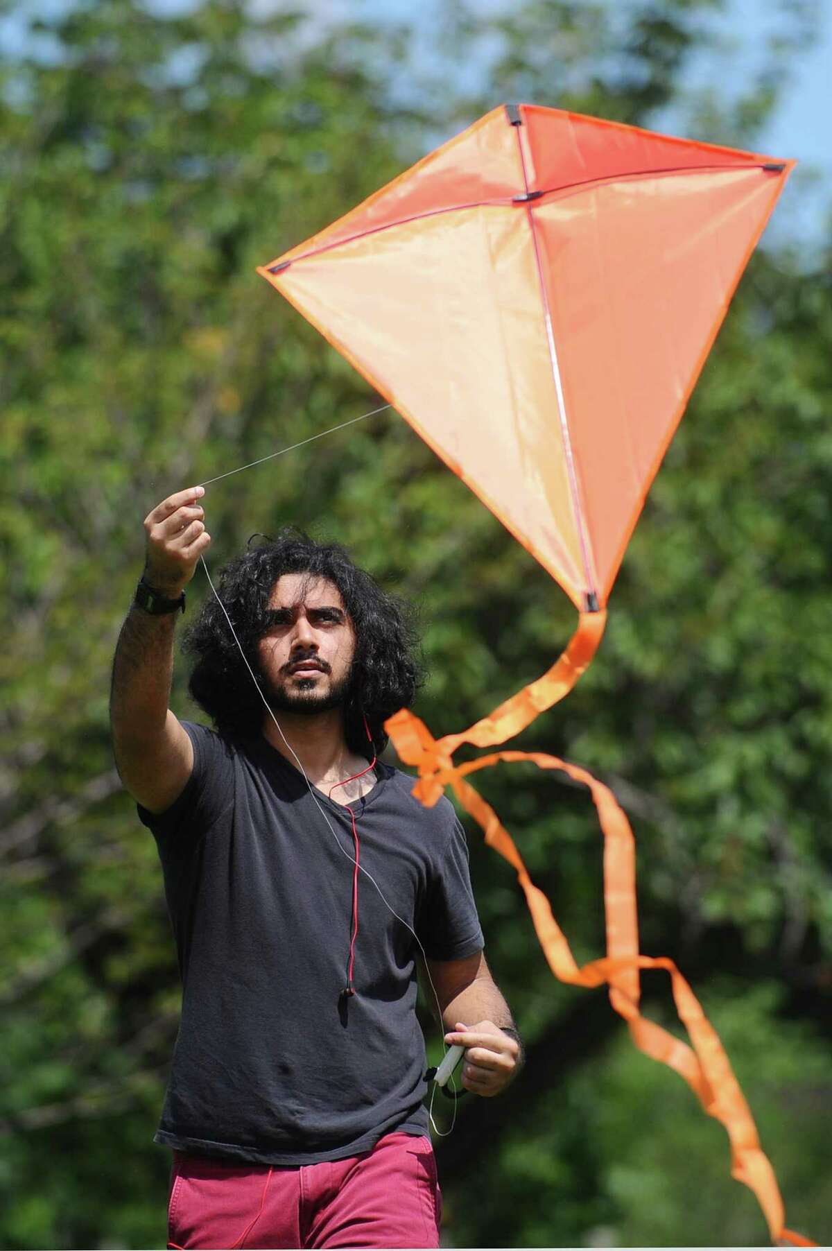 19-year-old Mohammad Faisal Vasanwala, of Stamford, flies a kite during the India Day Festival at Mill River Park in Stamford, Conn. on Sunday, August 13, 2017.