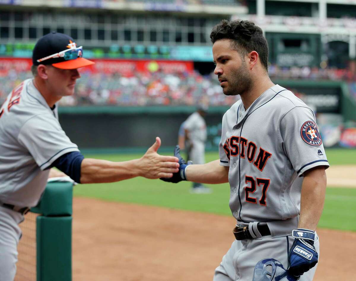Houston Astros manager A.J. Hinch, left, congratulates Jose Altuve, right, for his solo home run against the Texas Rangers in the fourth inning of a baseball game, Sunday, Aug. 13, 2017, in Arlington, Texas. (AP Photo/Tony Gutierrez)
