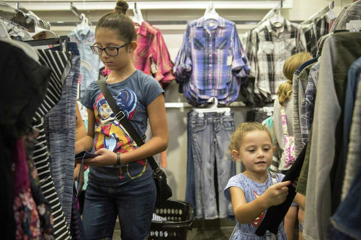 Megan Alverson, 13, and Ariana Weber, 5, shop with their mom Ruthie Patron, not pictured, at Kohl's in San Antonio, Texas during tax free weekend on August 13, 2017. Ray Whitehouse / for the San Antonio Express-News