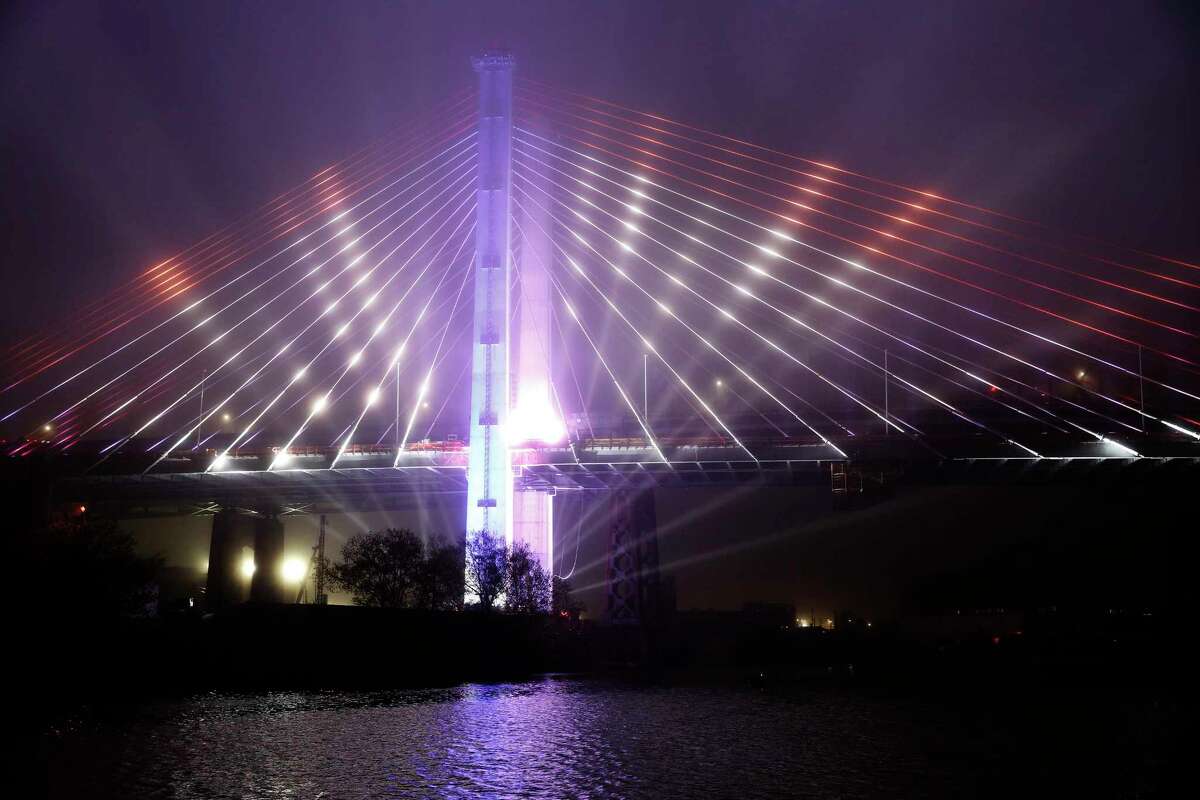 FILE - In this April 27, 2017, file photo, a performance of the "New York Harbor of Lights" is featured at the grand opening of the new Kosciuszko Bridge span connecting Brooklyn and Queens, in New York. Gov. Andrew Cuomo liked the idea of stringing New York City's bridges with high-tech lights that change color and pulsate to the beats of Broadway showtunes. But the plan, meant to delight tourists and residents alike, is sputtering amid criticism that the money for the lights should have gone to the city's beleagured subway system. (AP Photo/Kathy Willens, File) ORG XMIT: NYR202