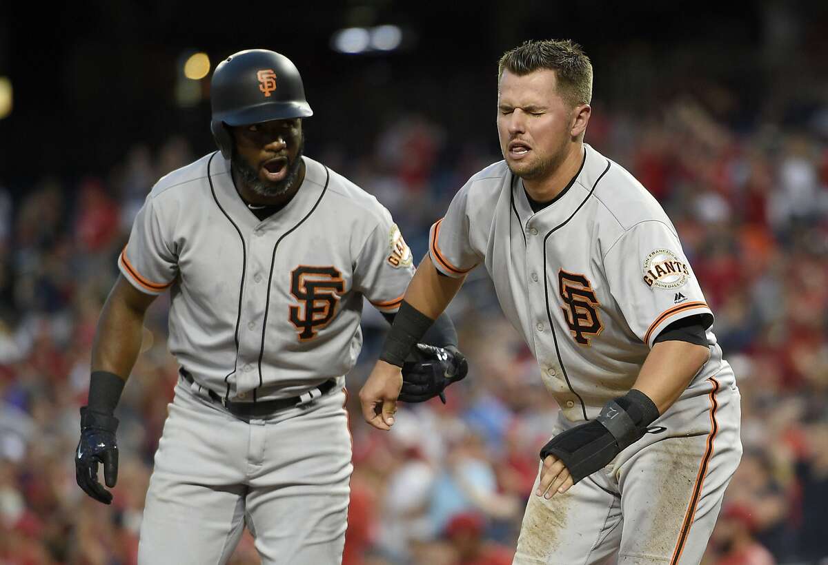 San Francisco Giants' Denard Span, left, helps Joe Panik, right, after Panik was out at home by Washington Nationals catcher Matt Wieters during the fourth inning of the second baseball game of a split doubleheader, Sunday, Aug. 13, 2017, in Washington.