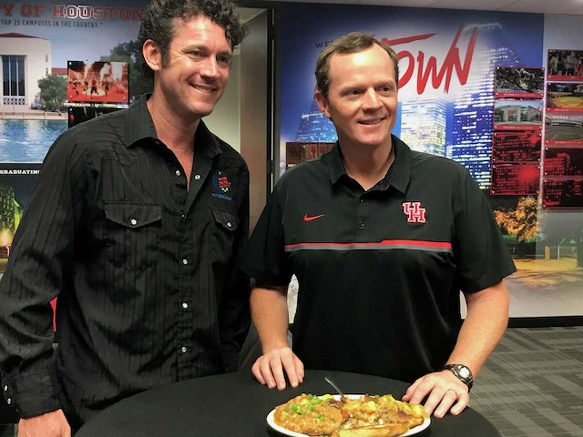 BB's Cafe owner Brooks Bassler and University of Houston football coach Major Applewhite prepare to dig in on the restaurant's dish named after Applewhite.