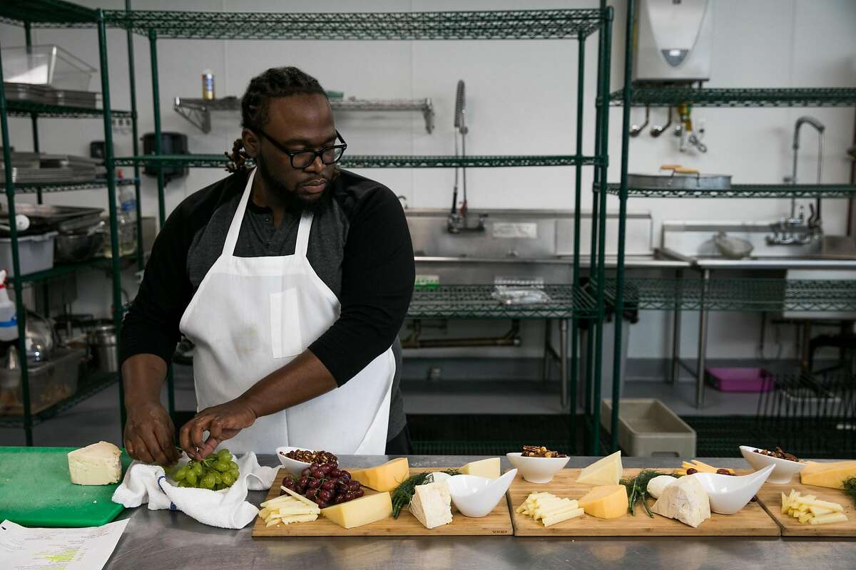 Assistant chef Chris Taylor prepares dishes for an upcoming event at The RedDoor Catering in Oakland, Calif. on Friday, July 7, 2017.