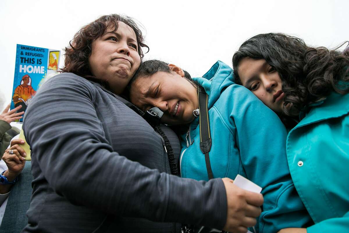 Maria Mendoza-Sanchez comforts her daughters, Melin Sanchez, 21, and Elizabeth Sanchez, 16, at the Highland Hospital in Oakland, Calif. Monday, August 14, 2017.