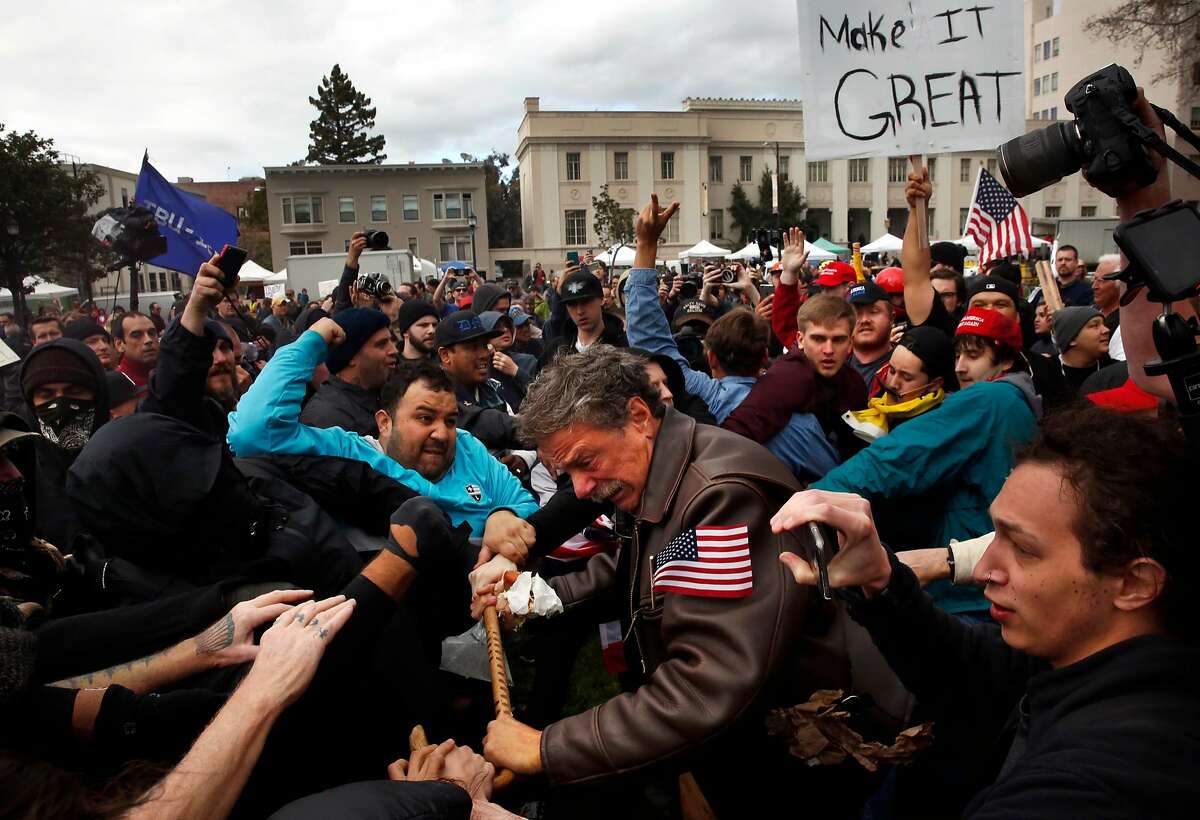 Tom Condon of San Francisco, center, a Trump supporter, becomes entangled in the center of a fight after attempting to push protesters back with his cane during a Pro-President Donald Trump rally and march at the Martin Luther King Jr. Civic Center park March 4, 2017 in Berkeley, Calif.