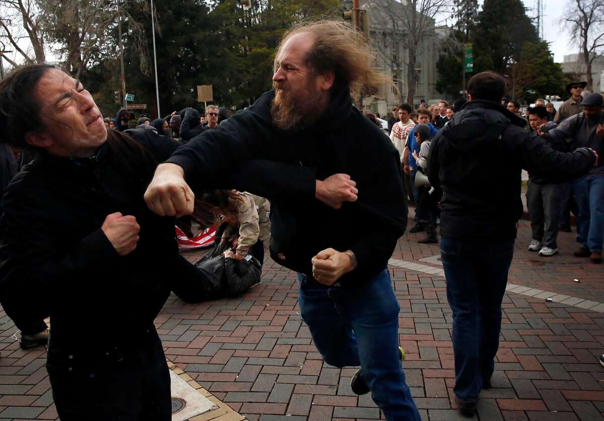 A Trump supporter trades blows with an anti-Trump protester in the street during a pro-President Donald Trump rally and march at the Martin Luther King Jr. Civic Center park March 4, 2017 in Berkeley, Calif.