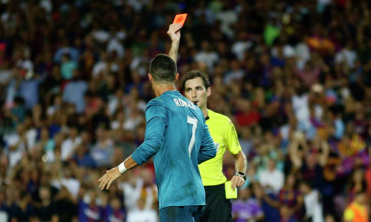 Referee Ricardo de Burgos, right, shows a red card to Real Madrid's Cristiano Ronaldo during the Spanish Supercup, first leg, soccer match between FC Barcelona and Real Madrid at the Camp Nou stadium in Barcelona, Spain, Sunday, Aug. 13, 2017. (AP Photo/Manu Fernandez)