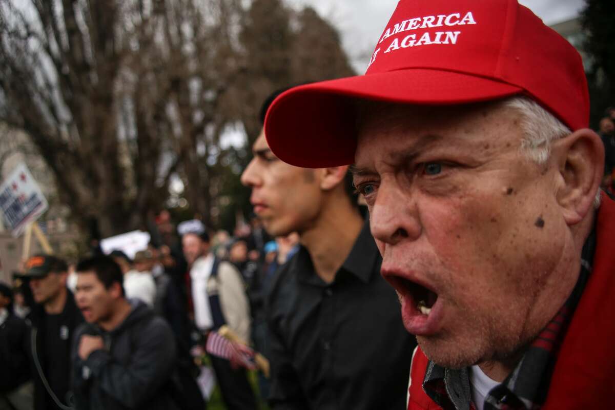 BERKELEY, USA - MARCH 4: A supporter U.S. President Donald Trump shouts at anti-Trump protestors after violence broke out during a free speech rally in Berkeley, United States on March 4, 2017. (Photo by Joel Angel Juarez/Anadolu Agency/Getty Images)