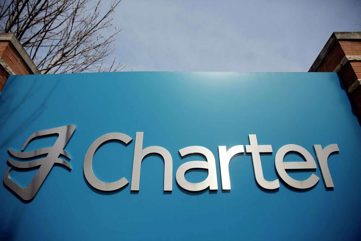 FILE - This Wednesday, April 1, 2015, file photo shows an entrance to Charter Communications' headquarters in Town and Country, Mo. (AP Photo/Jeff Roberson, File) ORG XMIT: NYBZ104