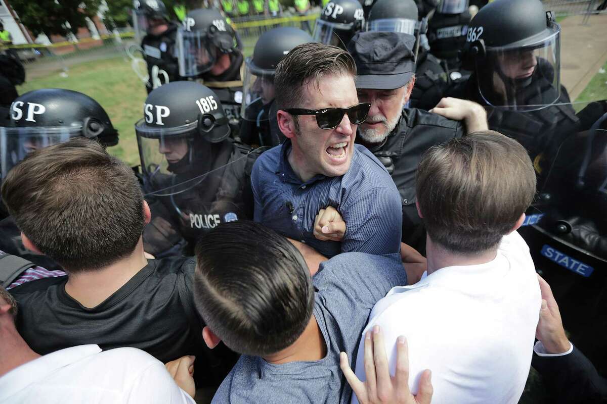 White nationalist Richard Spencer and his supporters clash with Virginia State Police in Lee Park after the "United the Right" rally was declared an unlawful gathering August 12, 2017 in Charlottesville, Virginia.