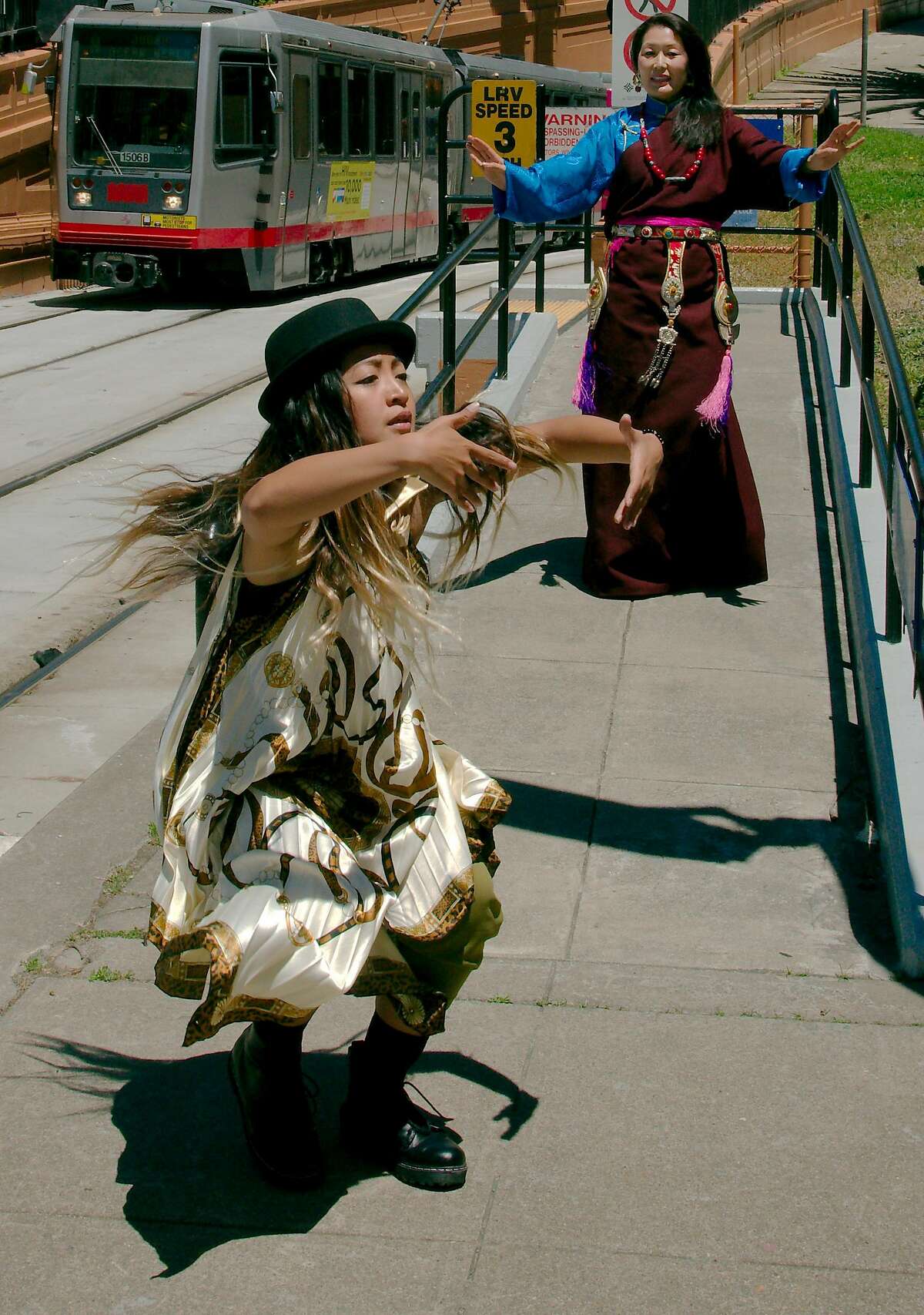 Sammay Dizon of Embodiment Project, left, and Tsering Wangmo of Chaksam-Pa perform in San Francisco Trolley Dances. Photo: Andy Mogg