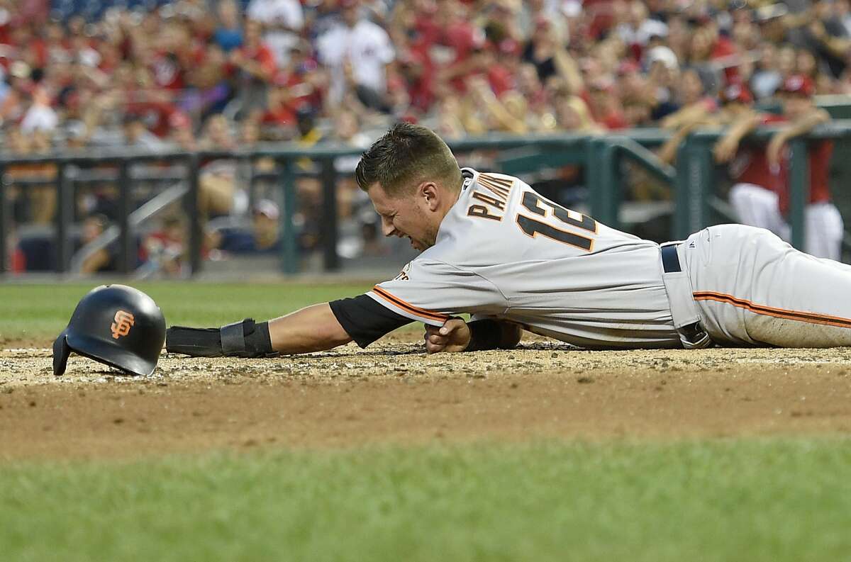 San Francisco Giants' Joe Panik reacts after he was tagged out at home during the fourth inning of the second baseball game of a split doubleheader against the Washington Nationals, Sunday, Aug. 13, 2017, in Washington.