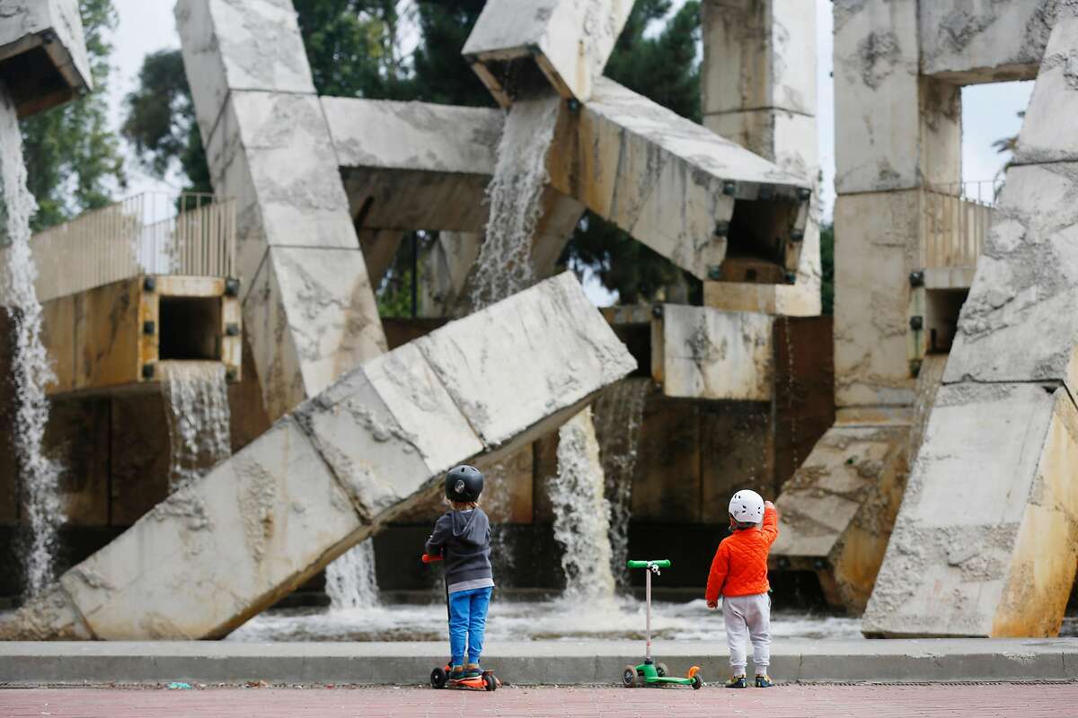 Two children take in the view of Vaillancourt Fountain as water flows from it at Justin Herman Plaza on Tuesday, August 15, 2017 in San Francisco, Calif.