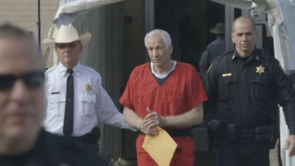 This photo shows Jerry Sandusky, center, in the documentary film, "Happy Valley," by director Amir Bar-Lev.