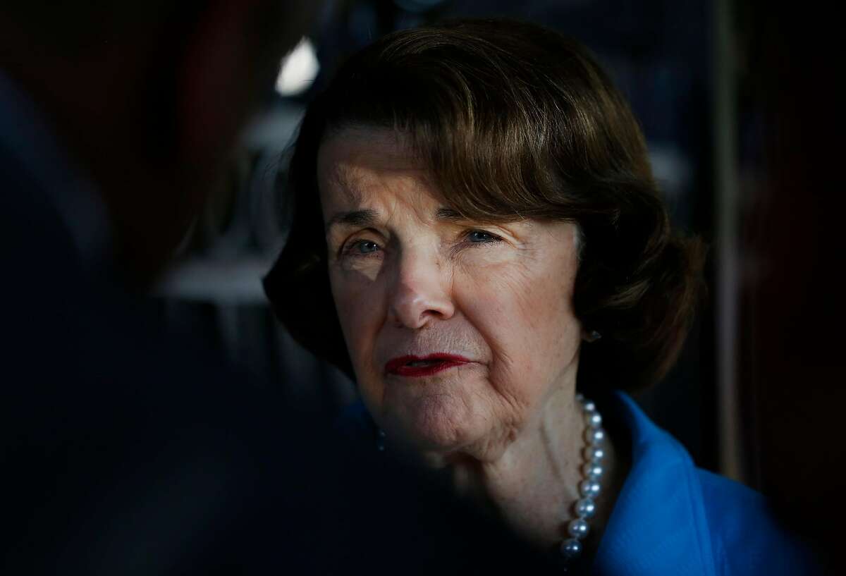 Senator Dianne Feinstein, right, speaks with members of the press on August 10, 2017 in Oakland, Calif.