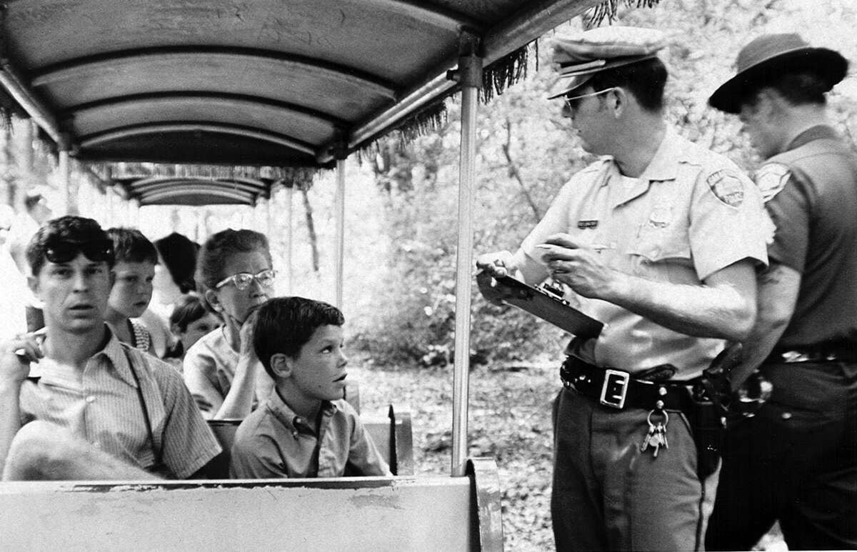 A San Antonio police officer takes statements after the Brackenridge Eagle Line's Old No. 99 was robbed at gunpoint on July 18, 1970. It was believed to be the first train robbery in the United States since 1923 and the first of a miniature train. Now the San Antonio Zoo, which owns the ride, plans to recreate the pop culture event on its 50th anniversary as a fundraiser.