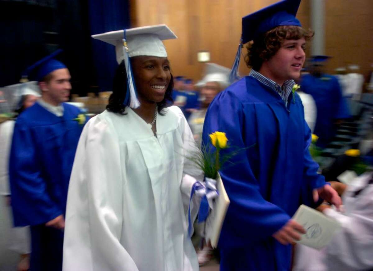 Shavonne Dash and William Collins wait in Bunnell High School for the beginning of the procession during the graduation ceremony on the football field Thursday, June 17, 2010.