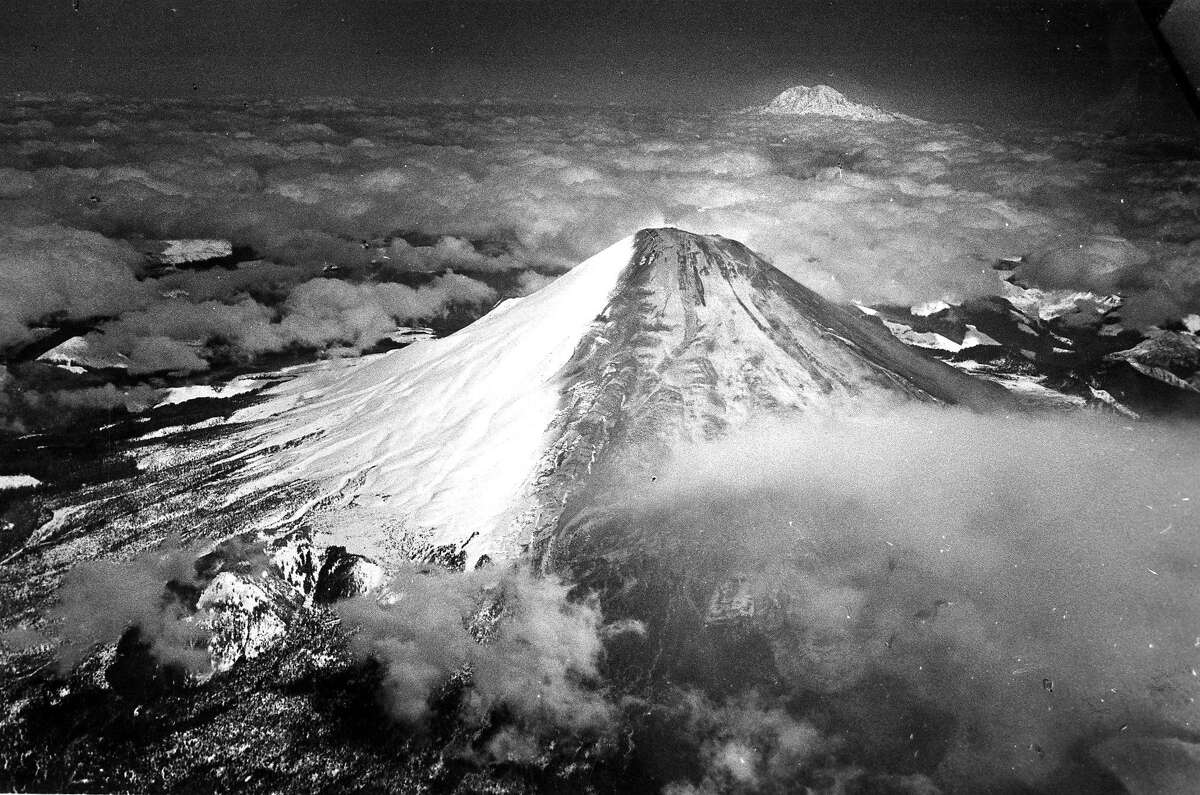 Aerial view Mount St. Helens after the volcano erupted, March 31, 1980 a more massive and devastating eruption would happen May 18, 1980 Mount Ranier is seen in the background. Photo ran 07/13/1988, P. B4