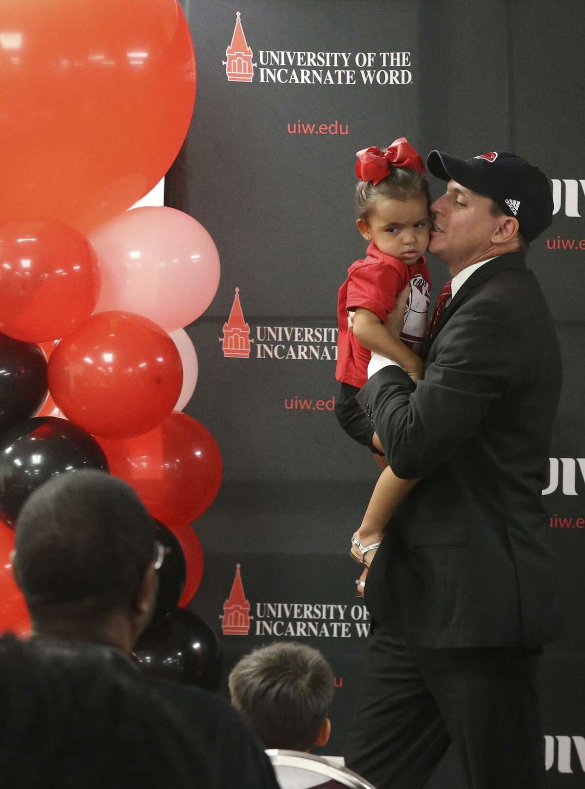 Brian Wickstrom (right) picks up his two-year-old-daughter Bricelle after it was announced Wednesday August 16, 2017 that he has become the University of the Incarnate Word’s new athletic director. Wickstrom joins UIW’s Cardinals after spending the last four years as director of athletics at the University of Louisiana Monroe. Wickstrom’s career spans nearly 20 years in collegiate athletics and has worked at Ohio University, the University of Missouri, Santa Clara University, the University of Michigan, the University of Texas at El Paso and the University of California, Riverside.