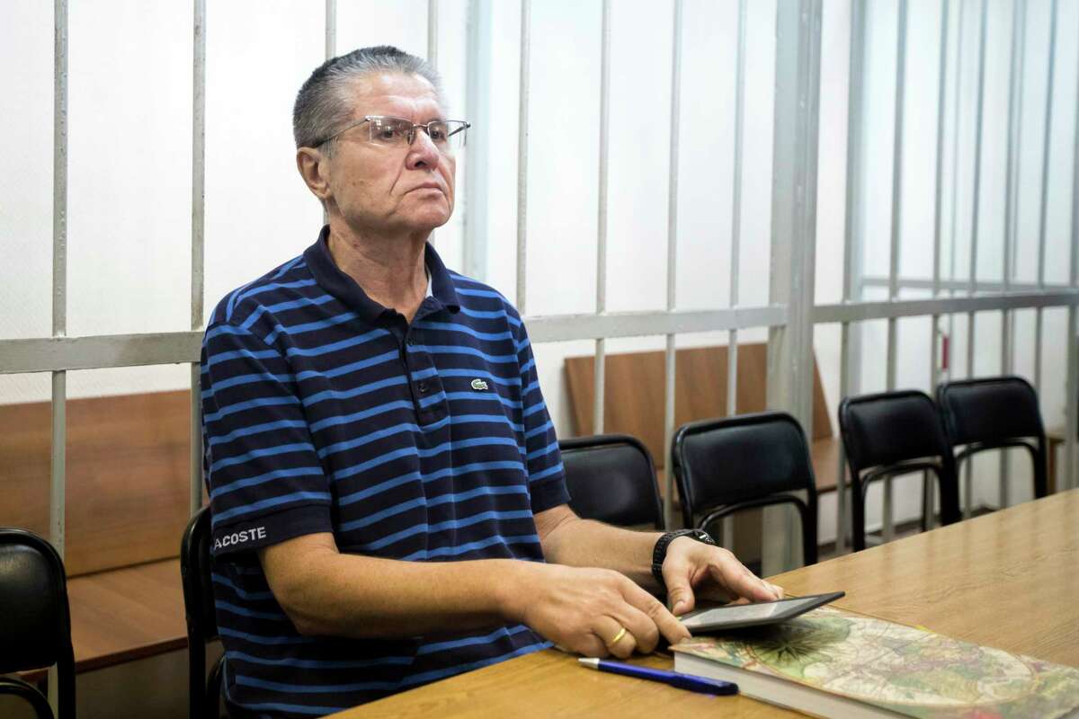 Former Russian Economic Development Minister Alexei Ulyukayev waits for a hearing in a court in Moscow, Russia, Wednesday, Aug. 16, 2017. Ulyukayev was detained last year after he allegedly accepted $2 million in cash from state oil company Rosneft in a sting set up by the FSB intelligence agency. Ulyukayev was largely seen as a victim of a Kremlin power play against Igor Sechin, chief executive of the oil company Rosneft and President Vladimir Putin's close ally. (AP Photo/Pavel Golovkin)