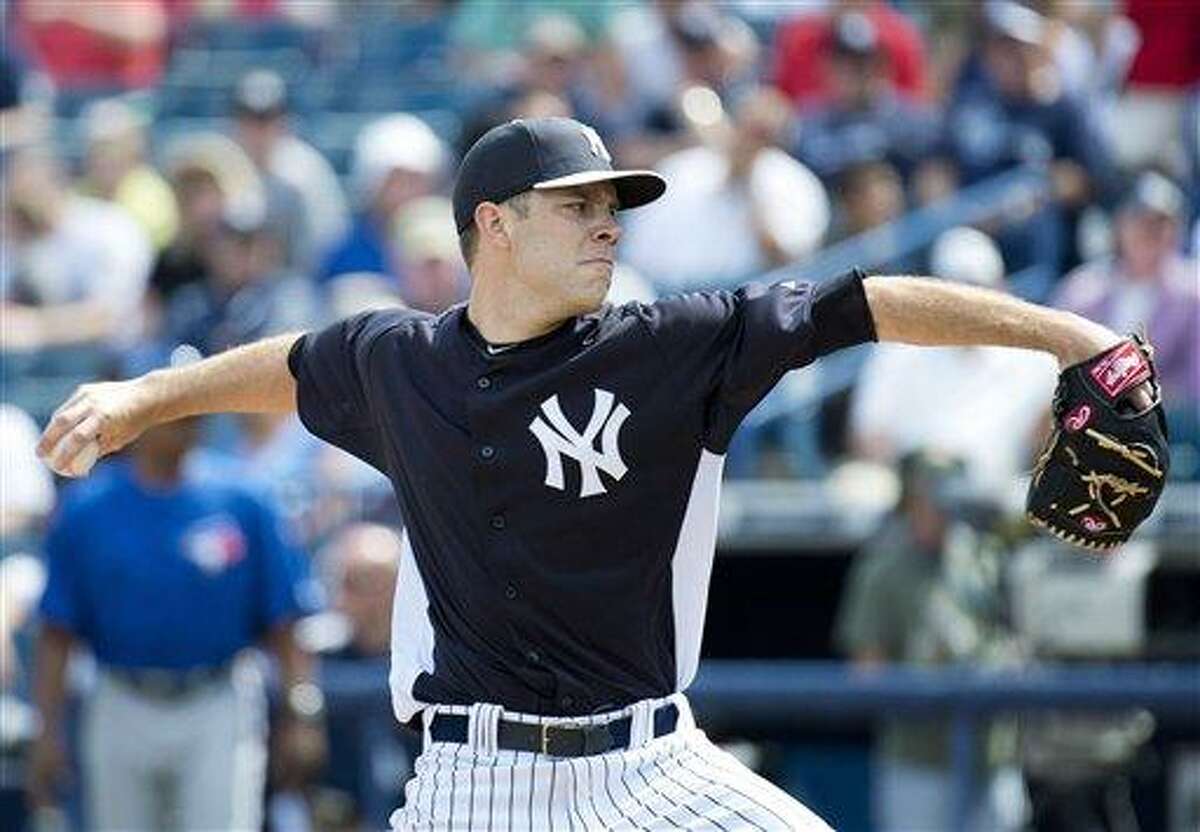New York Yankees starting pitcher David Phelps throws during the second inning of an exhibition spring training baseball game against the Toronto Blue Jays in Tampa, Fla., on Thursday, Feb. 28, 2013. (AP Photo/The Canadian Press, Nathan Denette)
