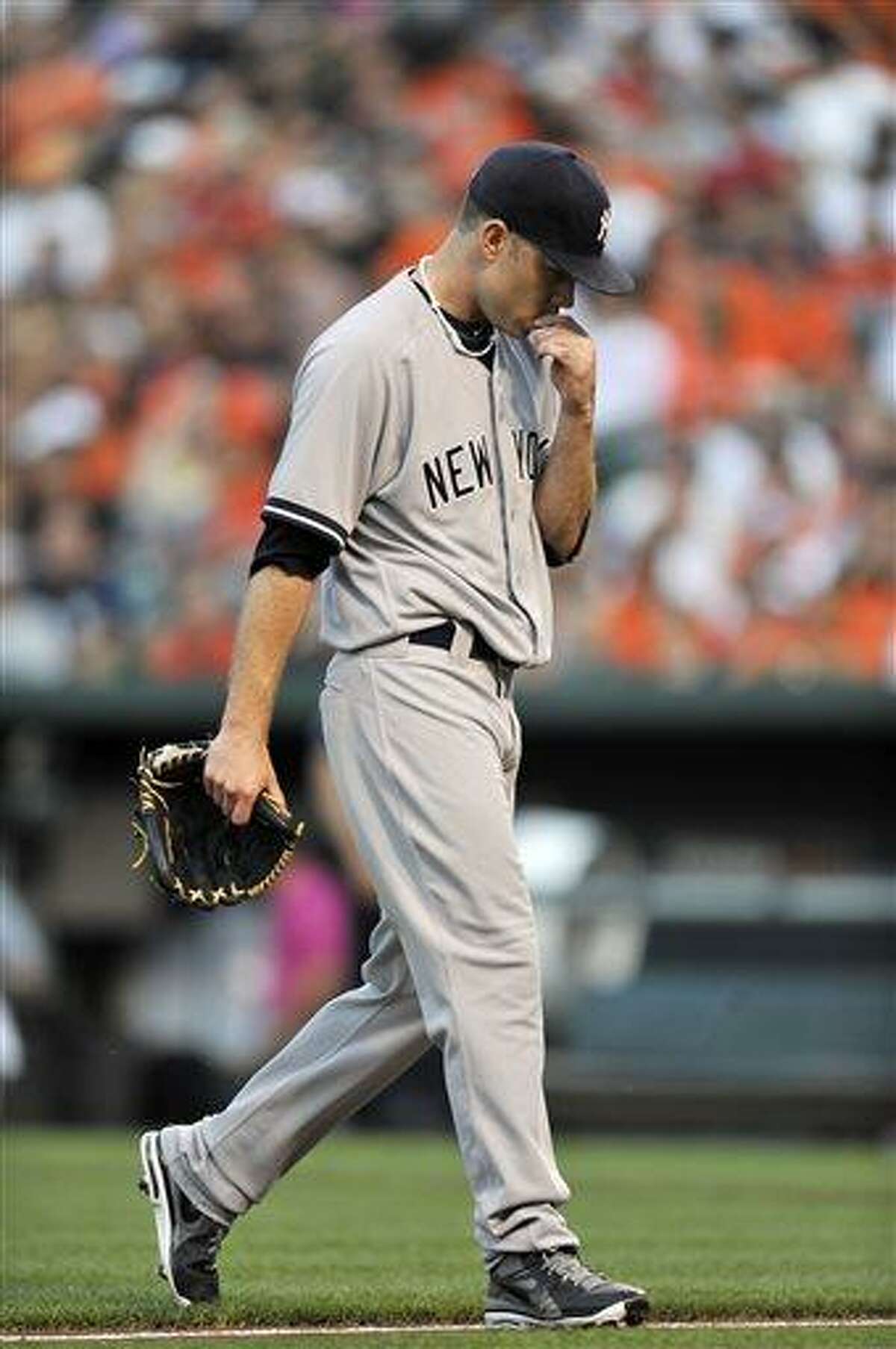 New York Yankees pitcher Kevin Phelps walks to the dugout after giving up four runs to the Baltimore Orioles in the first inning of a baseball game, Saturday, June 29, 2013, in Baltimore. (AP Photo/Gail Burton)