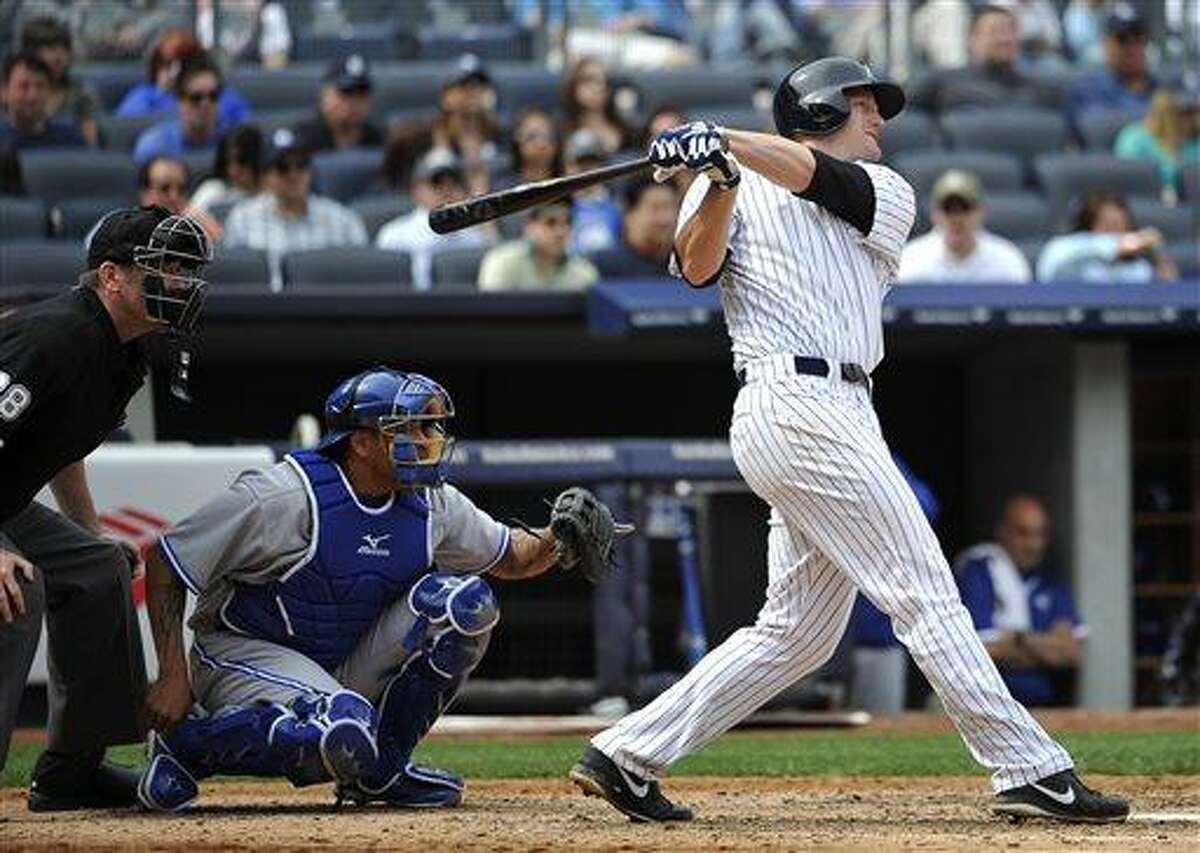 New York Yankees' Lyle Overbay, right, hits a two-run home run off Toronto Blue Jays starting pitcher R.A. Dickey in the seventh inning of a baseball game at Yankee Stadium, Sunday, April 28, 2013, in New York. (AP Photo/Kathy Kmonicek)