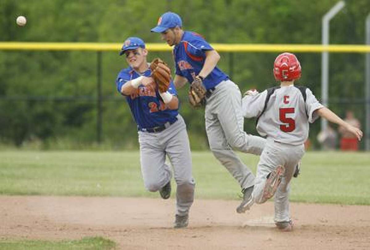 JOHN HAEGER @OneidaPhoto on Twitter/ONEIDA DAILY DISPATCH Mitch Cavanagh (24) makes a throw to first base as teammate Dylan Cafalone tries to get out of the way during a Section III playoff game last year.