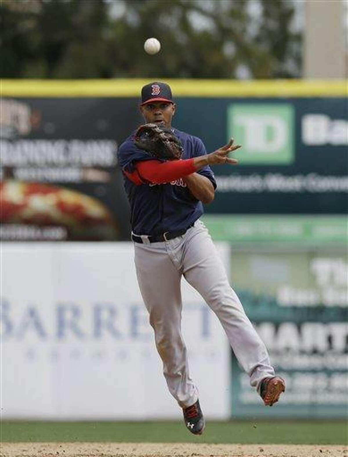 Boston Red Sox shortstop Xander Bogaerts (72) throws to first for a putout in a spring training baseball game against the Toronto Blue Jays in Dunedin, Fla., Friday, March 22, 2013. (AP Photo/Kathy Willens)