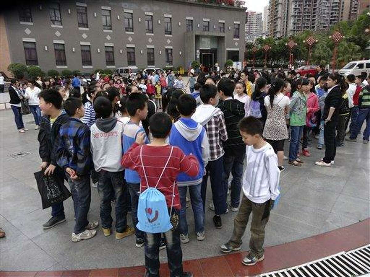 In this photo provided by China's official Xinhua News Agency, students gather outside their school buildings to avoid aftershocks of an earhtquake, in Dazhou, southwest China's Sichuan Province, Saturday, April 20, 2013. People were killed Saturday when a powerful earthquake jolted China's Sichuan province near the same area where a devastating quake struck five years ago, with state media warning the casualty toll could climb sharply. (AP Photo/Xinhua, Deng Liangkui) NO SALES