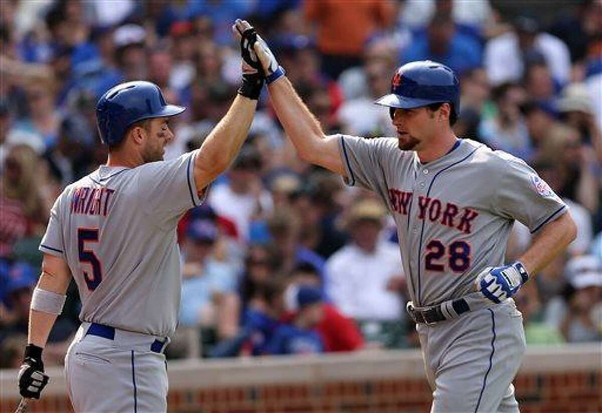 New York Mets' Daniel Murphy, right, is congratulated by teammate David Wright after hitting solo home run in the eighth inning of a baseball game against the Chicago Cubs in Chicago, Sunday, May 19, 2013. (AP Photo/Charles Cherney)
